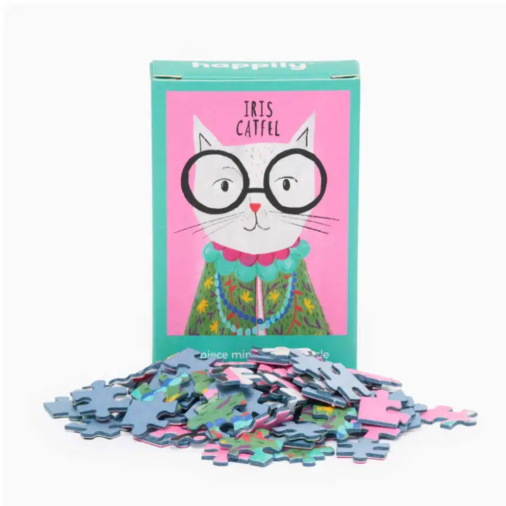 Puzzle with a cat illustration on the packaging and scattered pieces on a white background