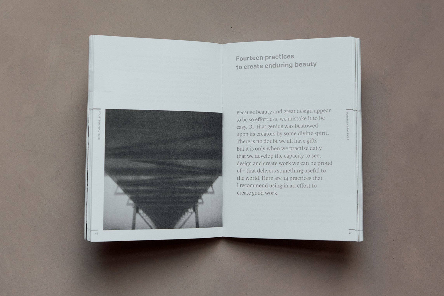 Open book on a brown surface with text and a black and white photo.