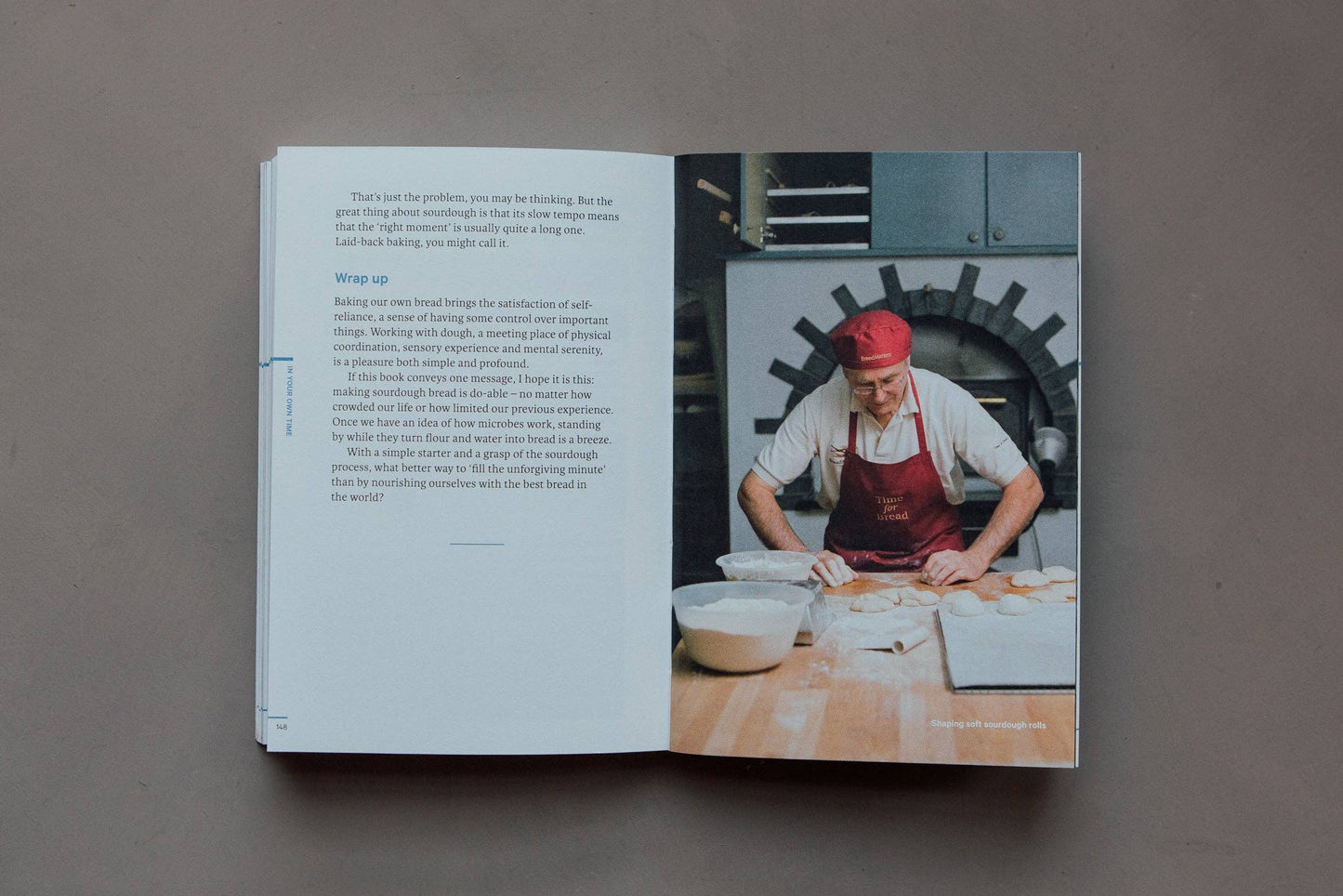 Open book showing a chef working in a kitchen with text on a gray background
