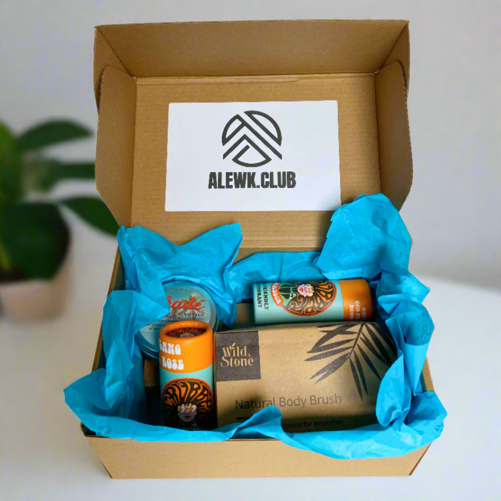 Open cardboard box with blue tissue paper containing skincare products and a sign for ALEWK CLUB.
