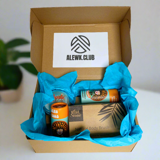 Open cardboard box with blue tissue paper containing skincare products and a sign for ALEWK CLUB.