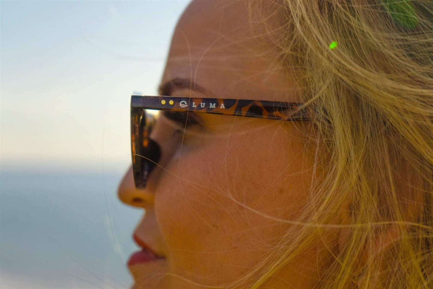 Person wearing sunglasses with a scenic background