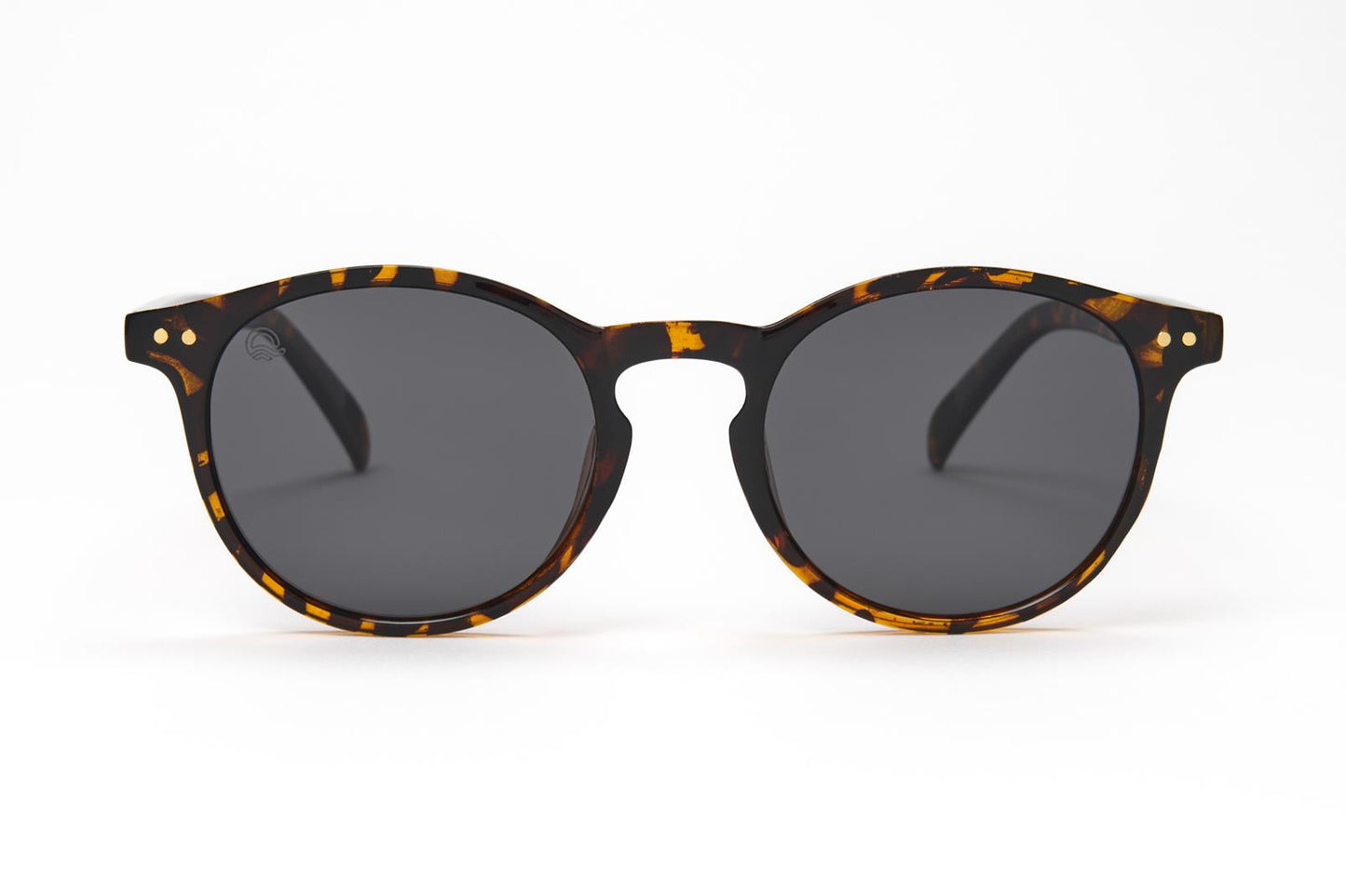 Sunglasses with tortoiseshell frame and dark lenses on a white background
