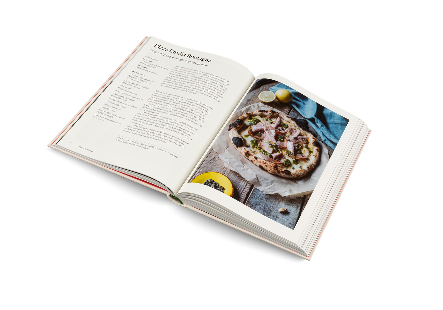 Open cookbook showing a pizza recipe with an image of a pizza on a white background