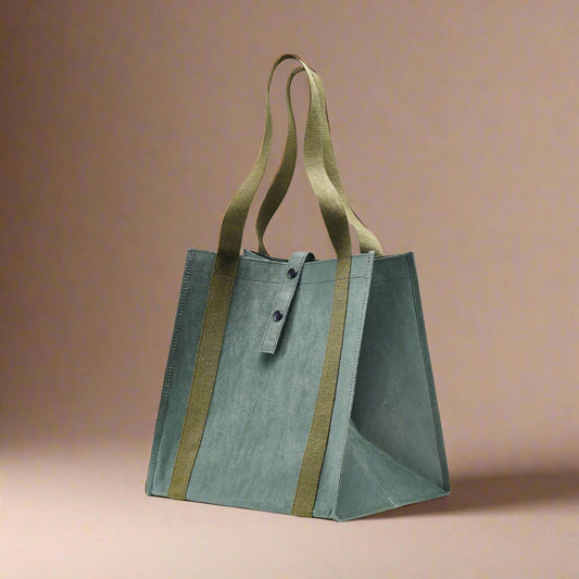 Green tote bag with brown straps on a white background