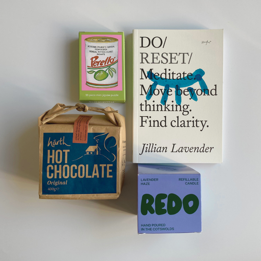 Collection of products including a book, hot chocolate box, and candle on a white background