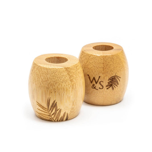 Two wooden toothbrush holders with 'WS' engraving on a white background