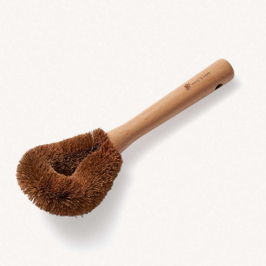 Wooden dish brush with bristle head on a white background