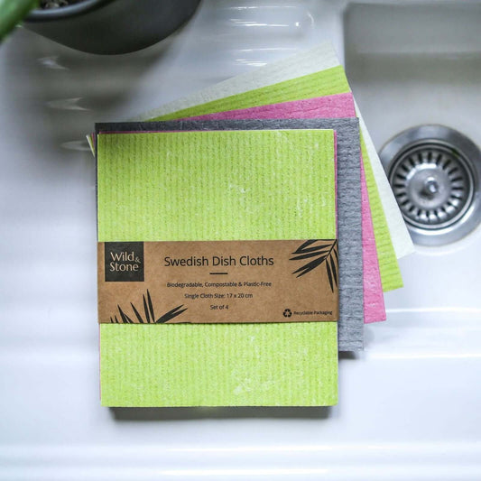 Compostable Swedish Dish Cloths - Set of 4 displayed in a sink, featuring vibrant colors and eco-friendly packaging.