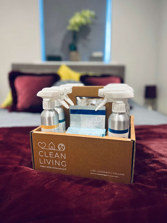Eco Friendly, Probiotic, Complete Cleaning Kit displayed on a bed with cleaning supplies in a stylish box.