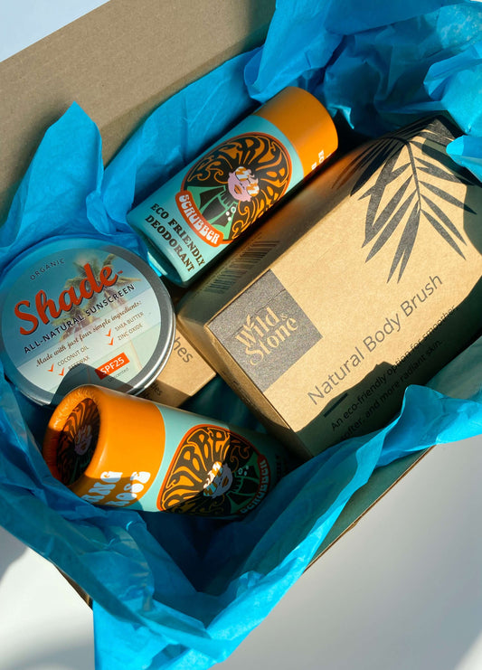 Eco Essentials Home Gift Set featuring bamboo toothbrushes, natural body brush, Ylang & Rose soap bars, and Shade all-natural sunscreen, arranged on a neutral background for a minimalist, sustainable lifestyle look