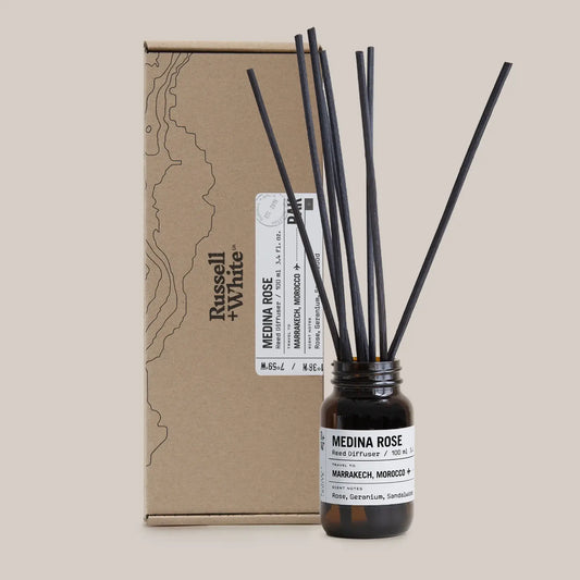 Reed diffuser with 'Medina Rose' label and packaging on a beige background
