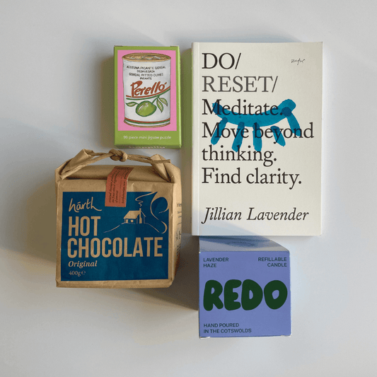 Collection of products including a book, hot chocolate box, and candle on a white background