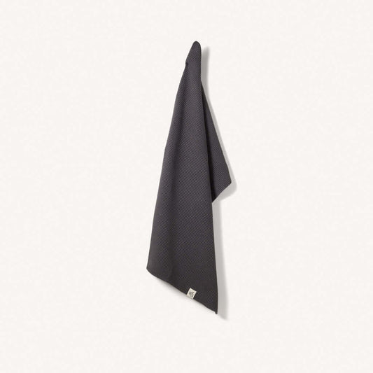 Organic Cotton Hand Towels hanging against a light background, showcasing their soft texture and absorbent quality.