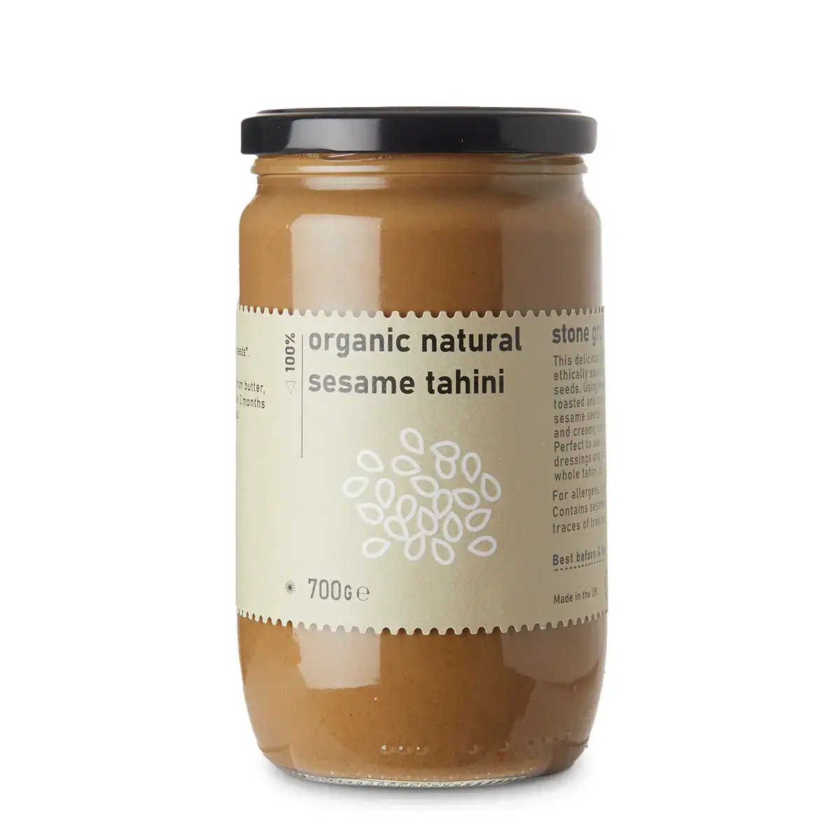 Jar of organic natural sesame tahini on a white background