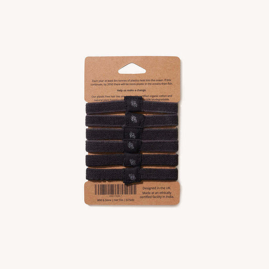 Set of black hair ties on a cardboard packaging with text and a barcode.