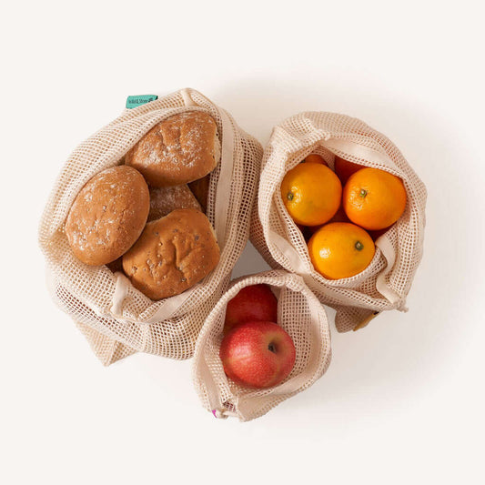 Reusable Mesh Produce Bags - Organic Cotton - 3 Pack filled with fruits and bread in natural cotton mesh.