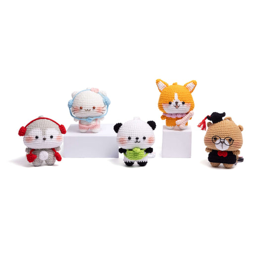 Set of five small animal plush toys on a white background