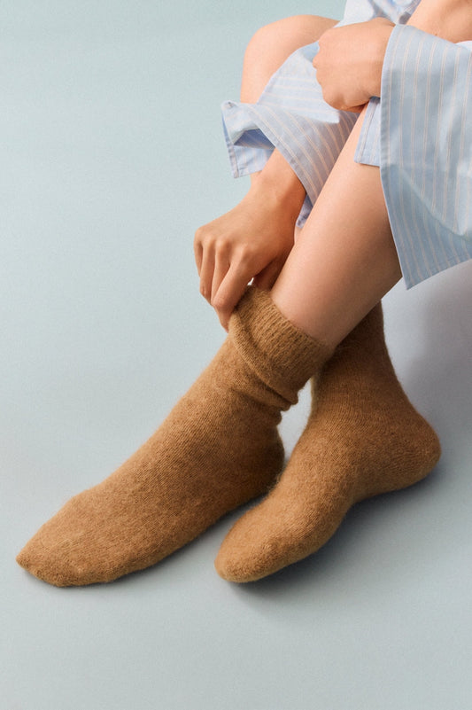 Cozy Alpaca Bed Socks shown on a person, featuring soft texture and warm feel, perfect for relaxing at home.