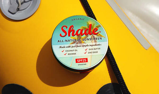 Shade All-Natural Sunscreen tin featuring coconut oil, beeswax, shea butter, and zinc oxide, SPF 25.