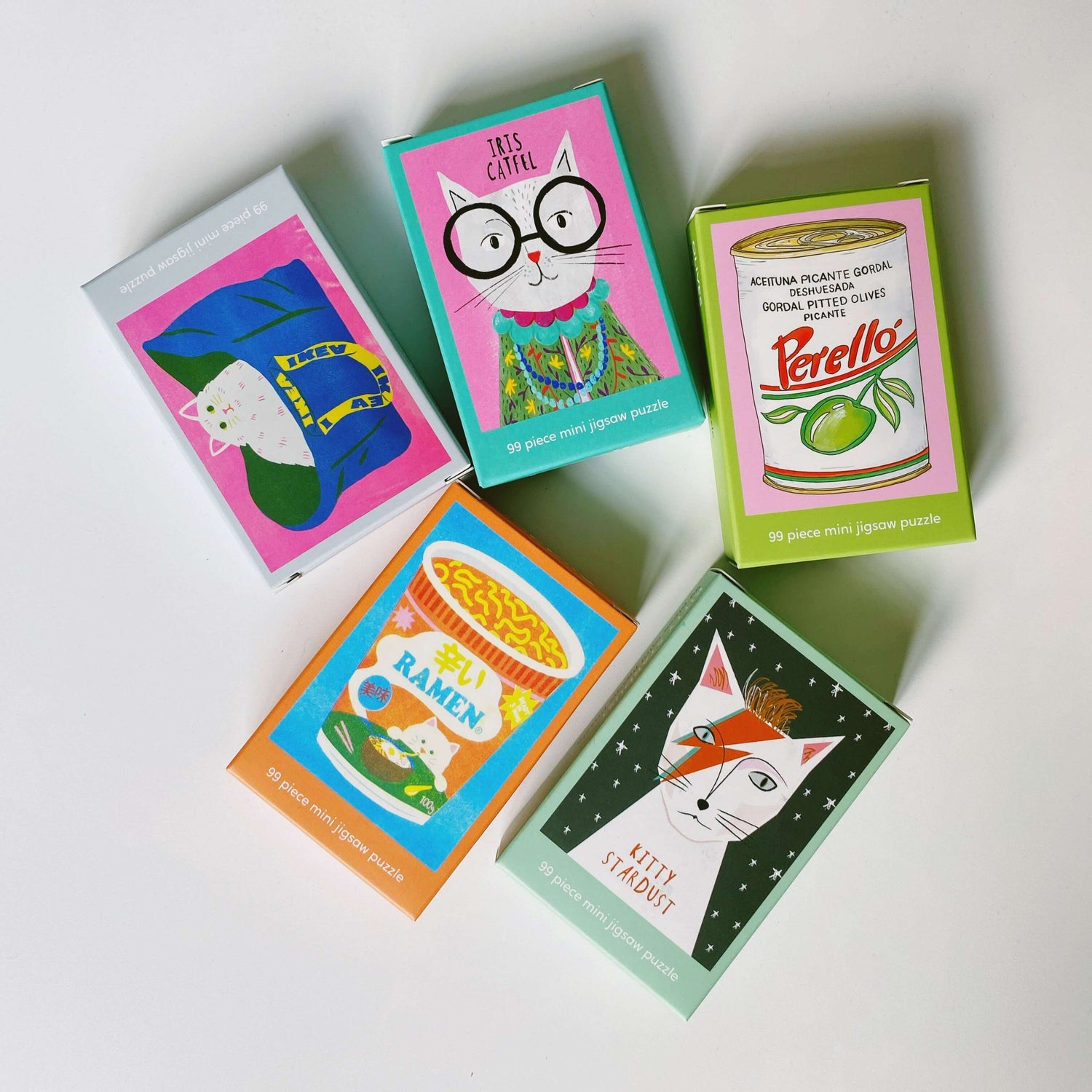 Colorful Happily Puzzles boxes featuring collage designs and fun themes on a white background.