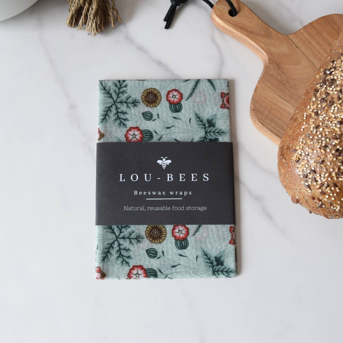 Lou-Bees beeswax wraps with floral design on a white surface