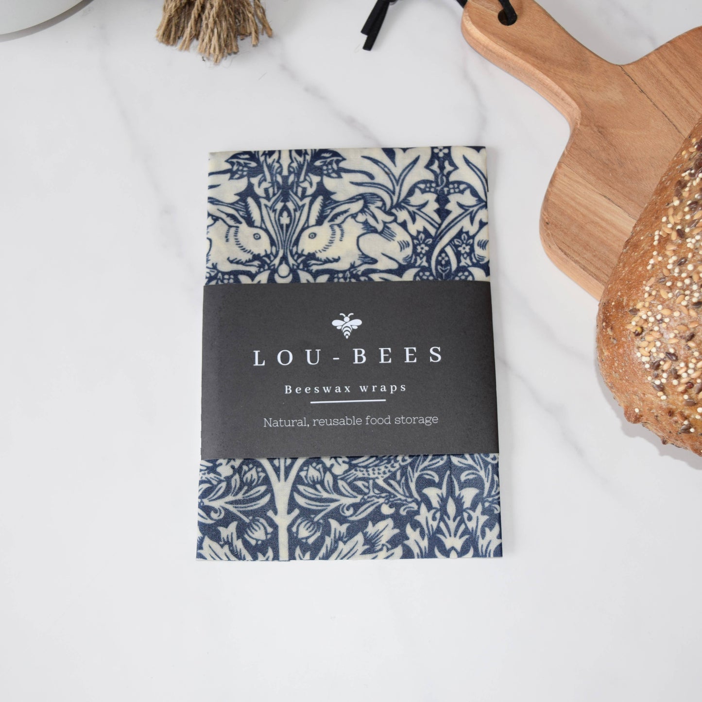 Lou-Bees beeswax wraps packaging with a decorative pattern on a white surface.