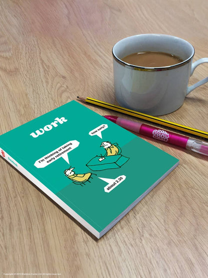Teal Modern Toss Retire Early A6 notebook on a wooden desk beside a mug and pencils