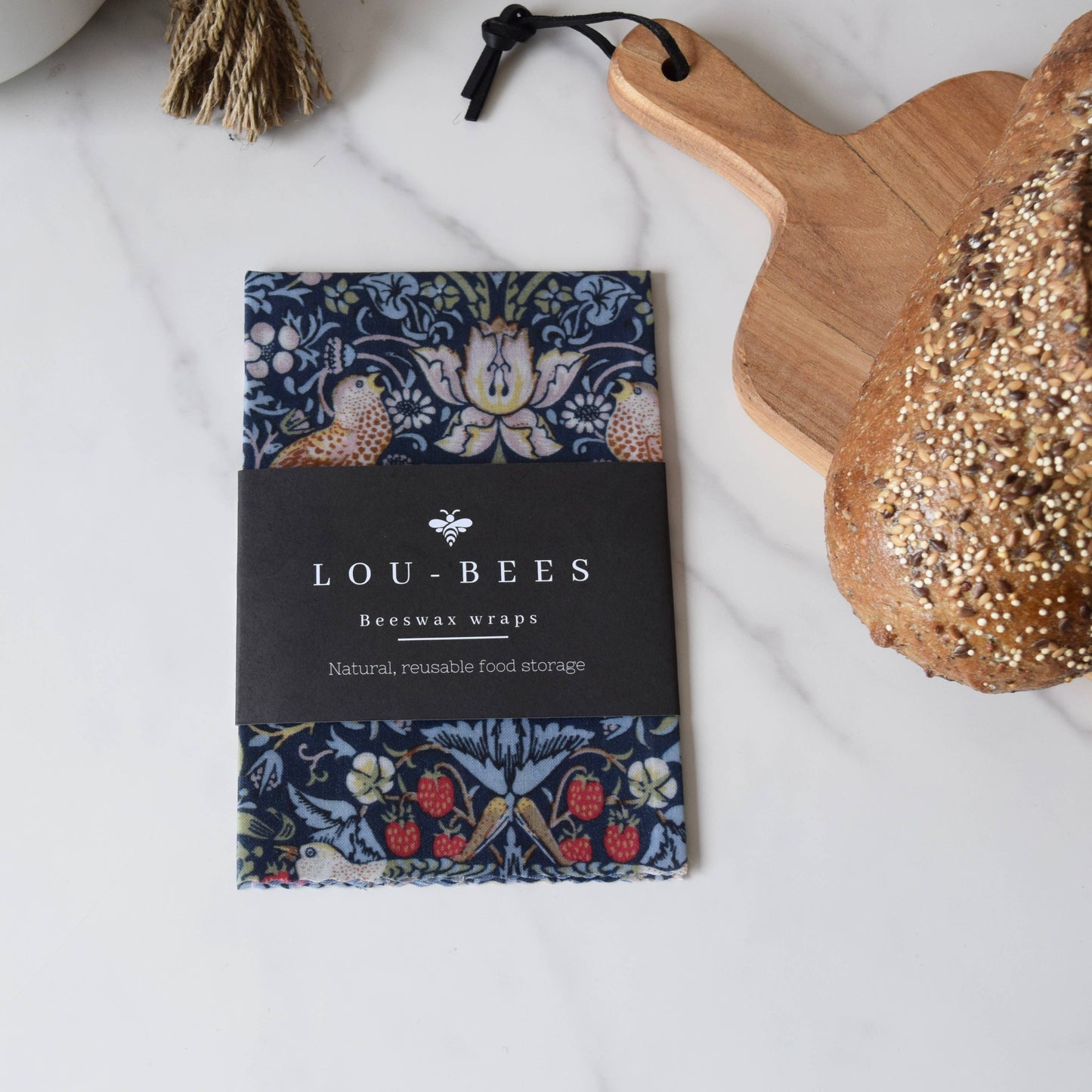 Lou-Bees beeswax wraps packaging with a decorative design on a white surface.