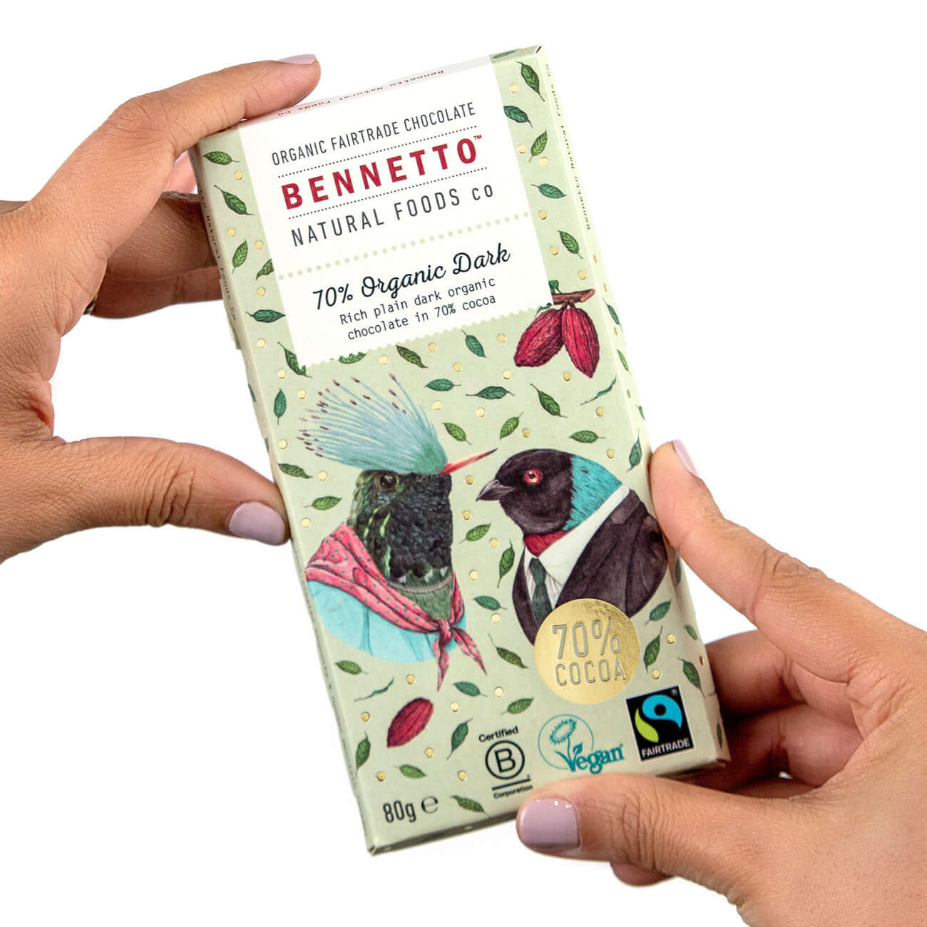 Hands holding Bennetto 70% Organic Dark chocolate bar featuring eco-friendly design and Fairtrade certification.