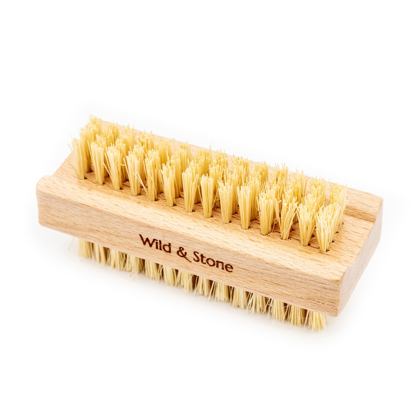 Wooden brush with natural bristles on a white background, branded 'Wild & Stone'.