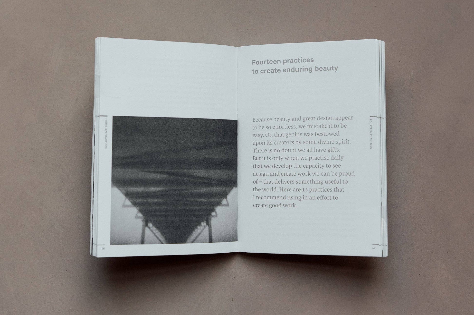 Open book on a brown surface with text and a black and white photo.