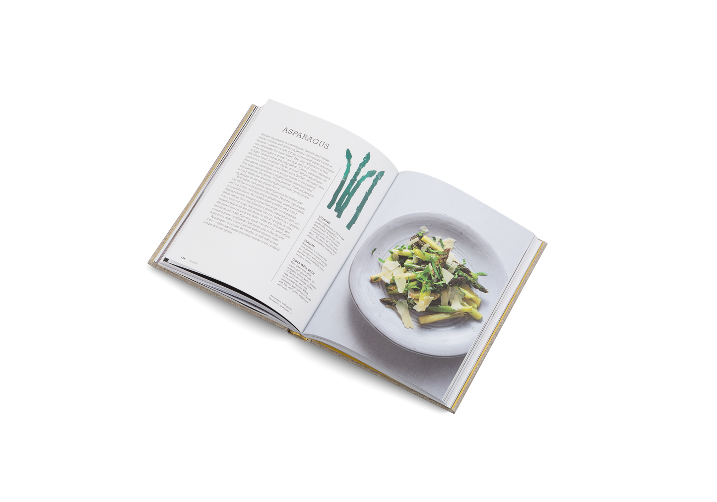 Open cookbook showing a plate of salad on a white background