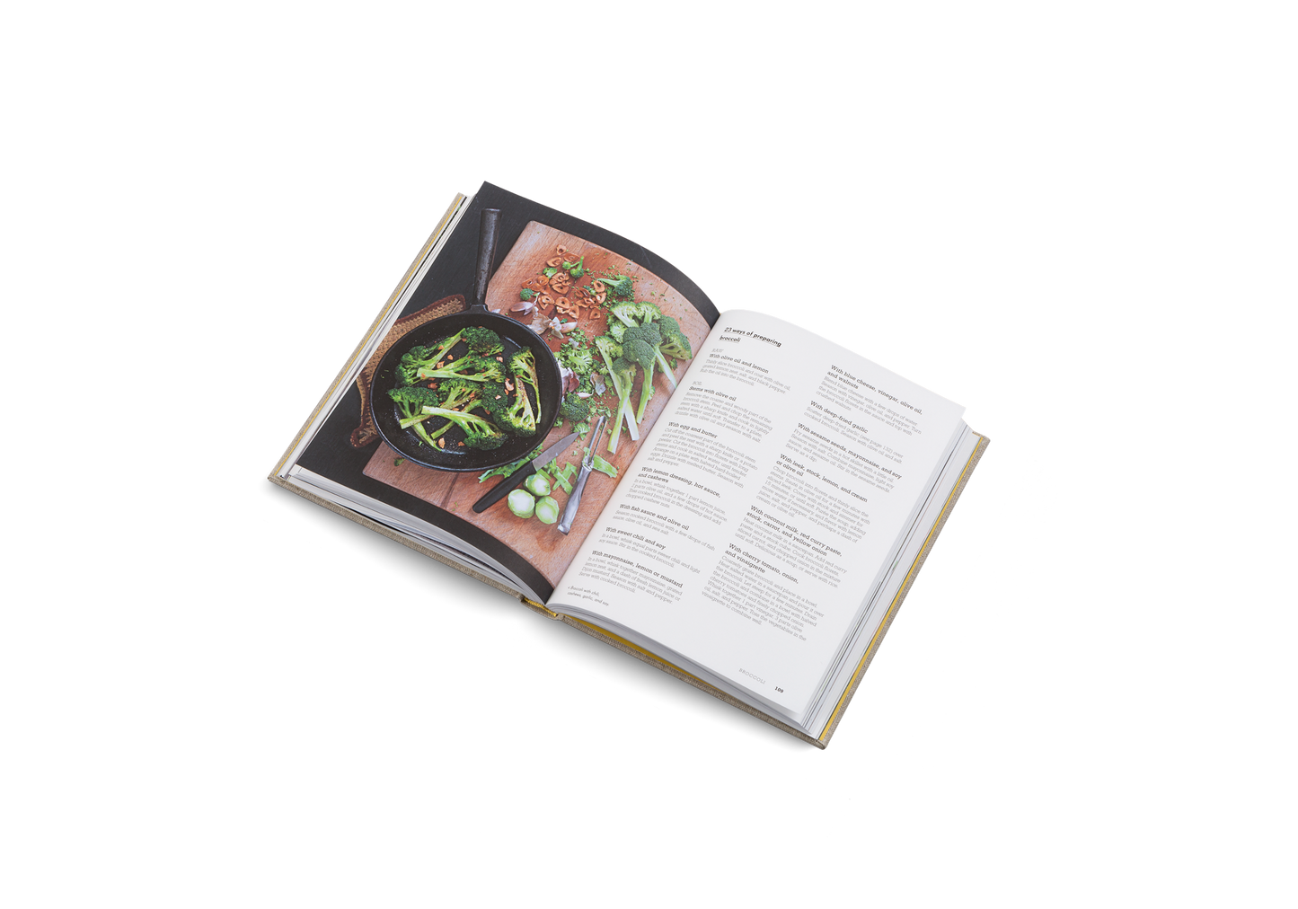 Open cookbook showing a page with a photograph of a dish and text on a white background