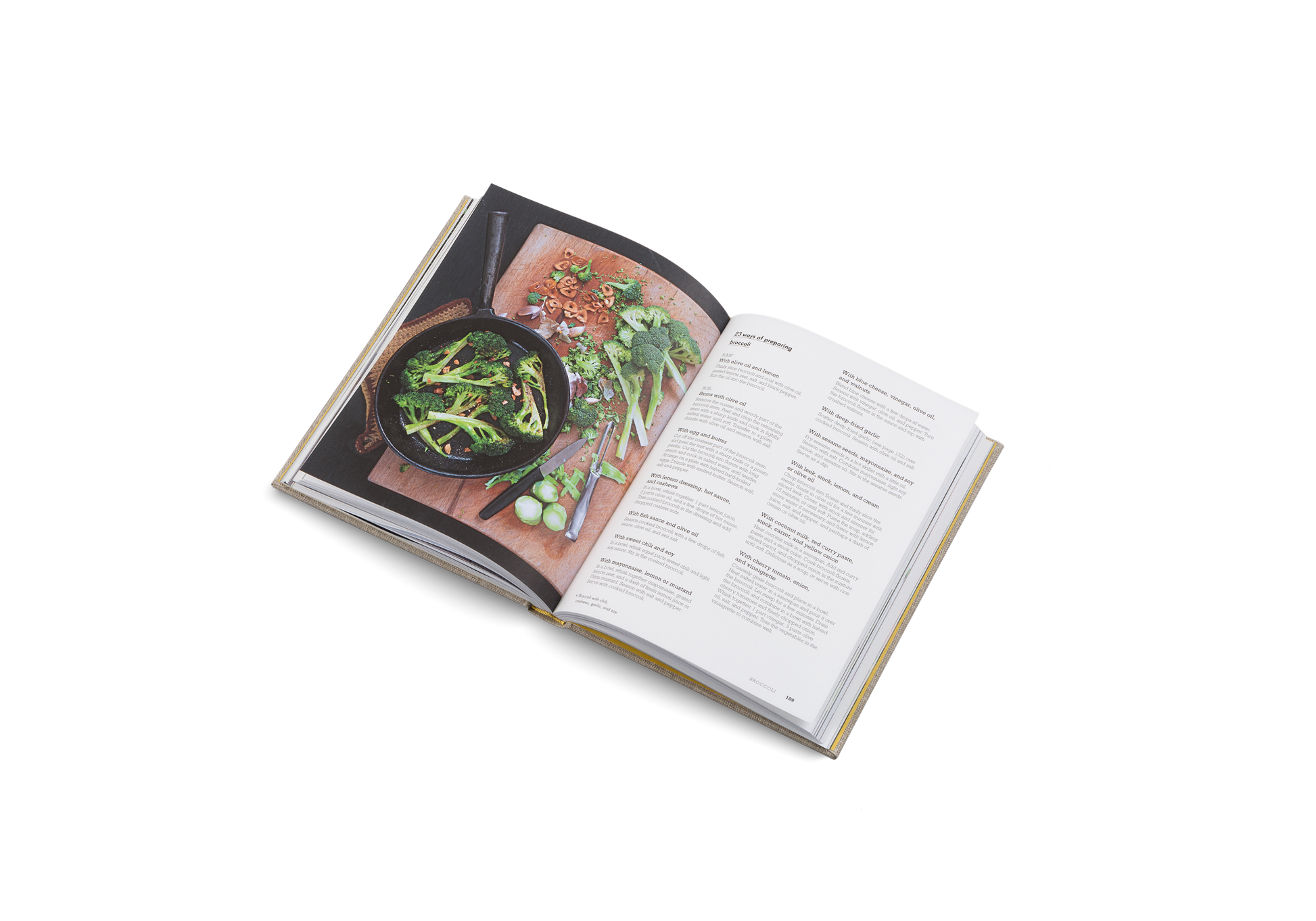 Open cookbook showing a page with a photograph of a dish and text on a white background