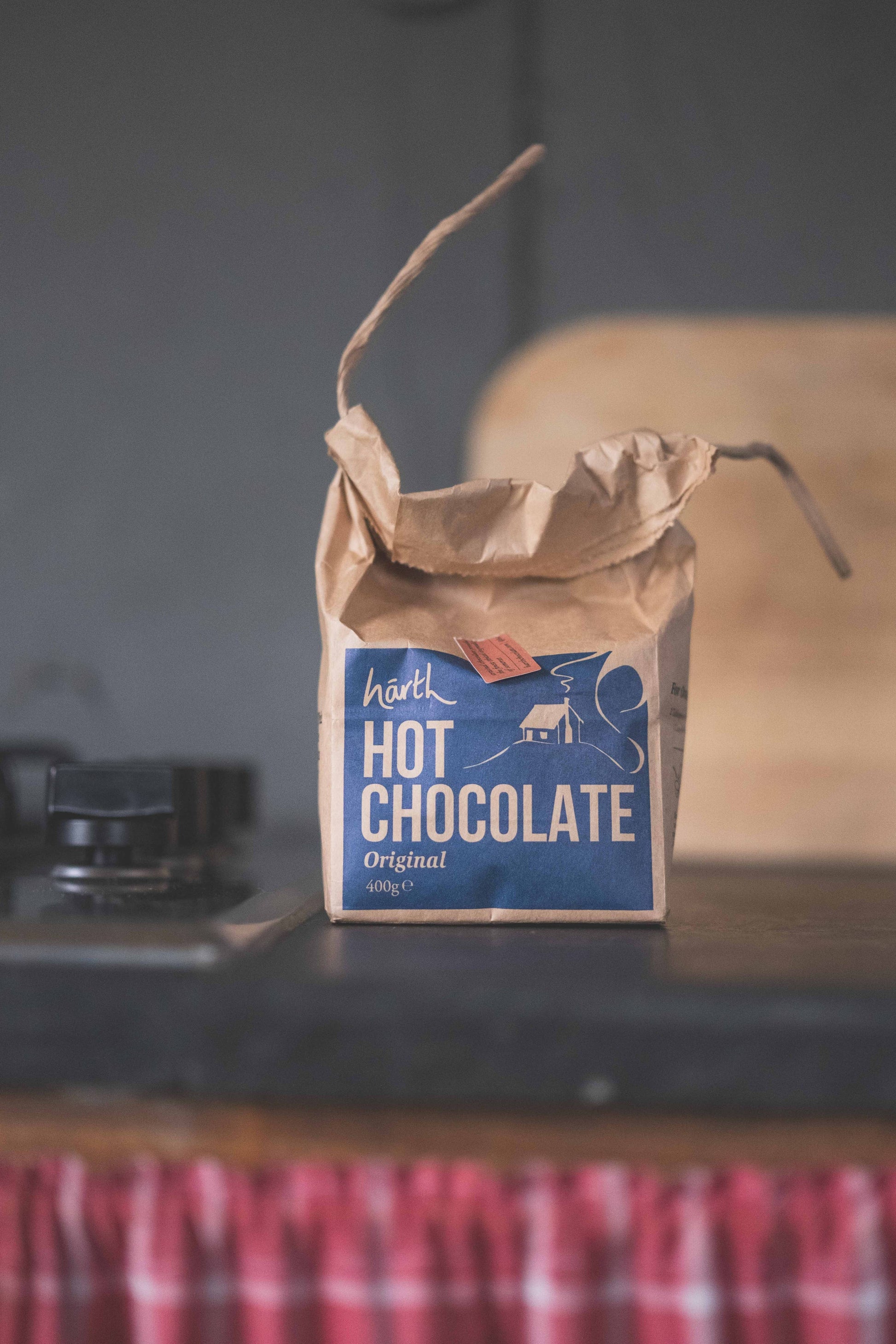 Bag of hot chocolate on a rustic surface with a blurred background