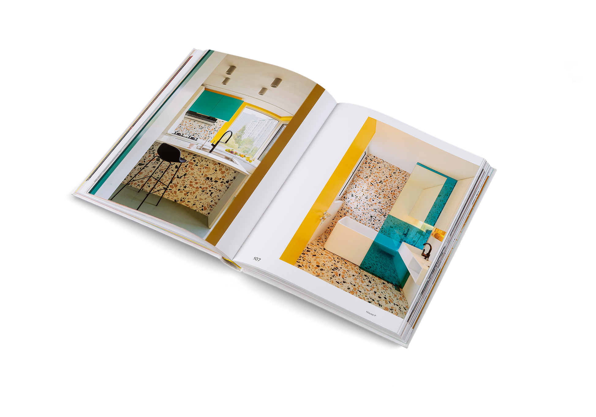 Open book showing interior design images with teal and yellow elements.