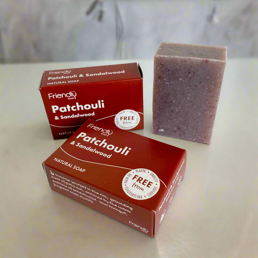 Two boxes and a bar of Friendly Soap Patchouli & Sandalwood on a white background