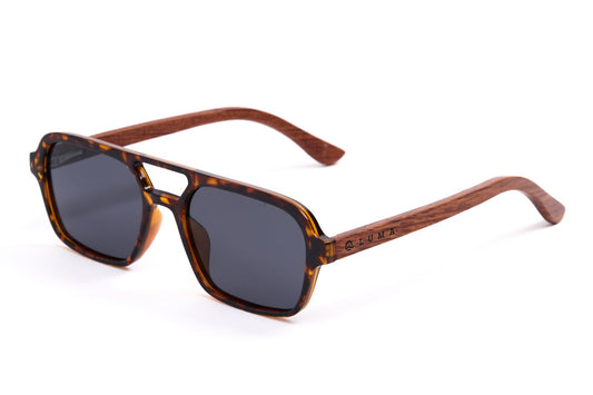 Sunglasses with tortoiseshell frame and dark lenses on a white background