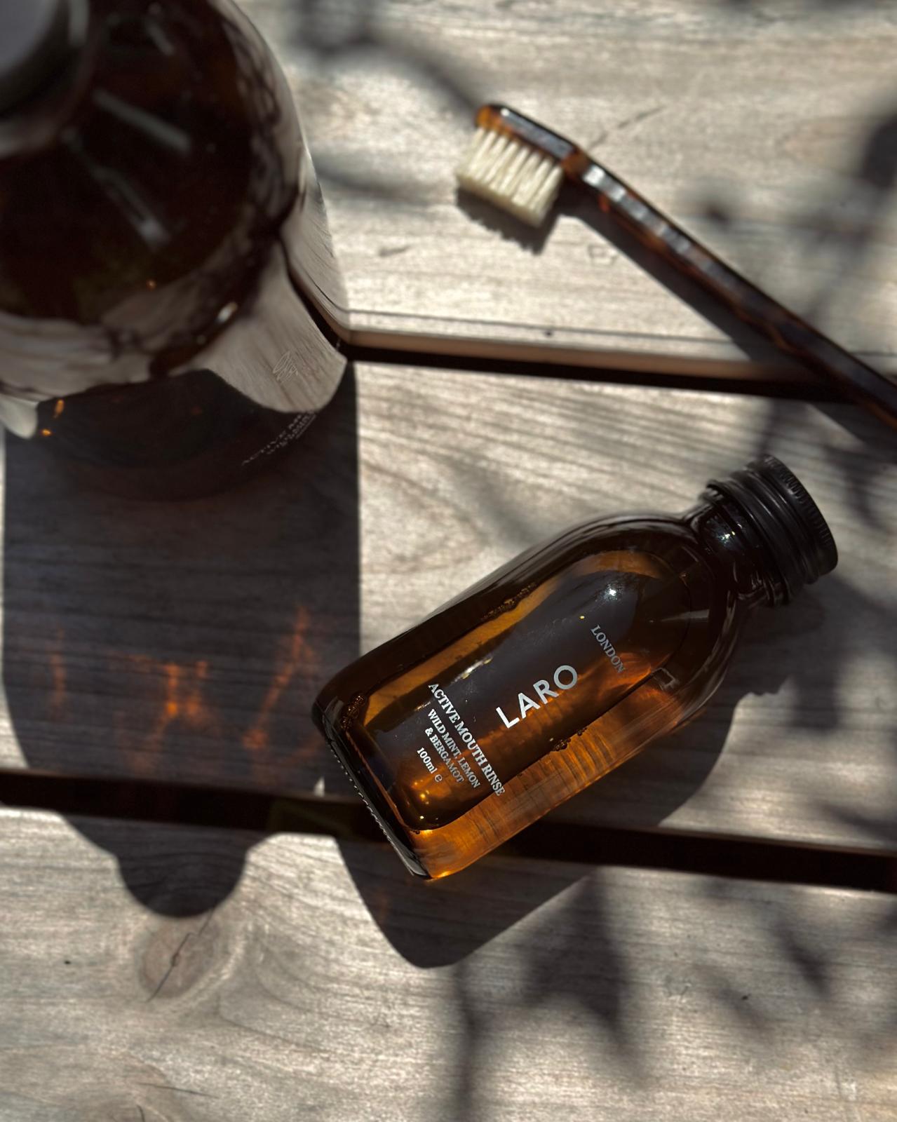 Travel Mouth Rinse, 100ml next to a toothbrush, highlighting its travel-friendly size and packaging.