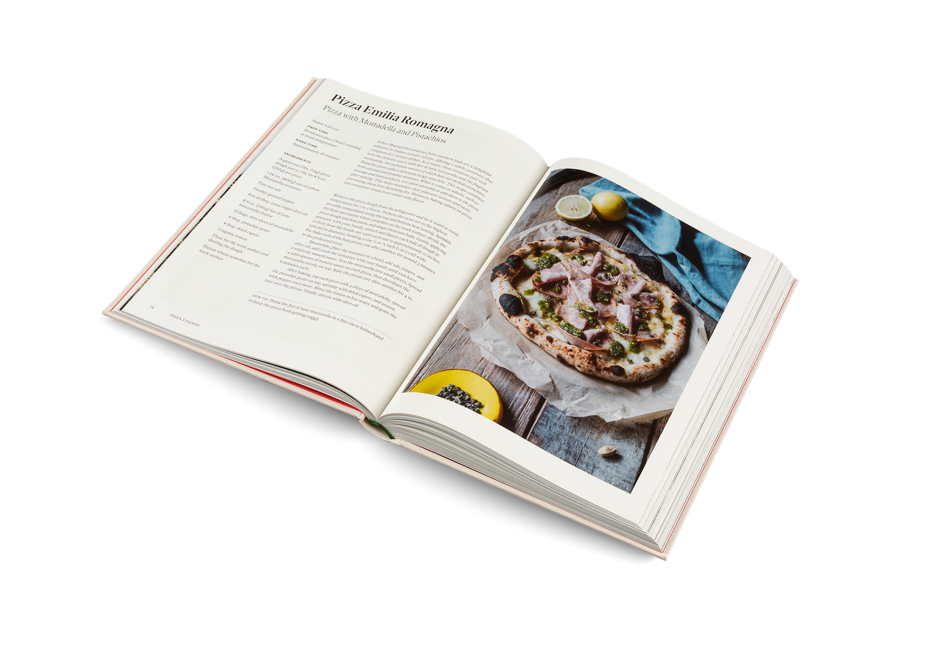 Open cookbook showing a pizza recipe with an image of a pizza on a white background