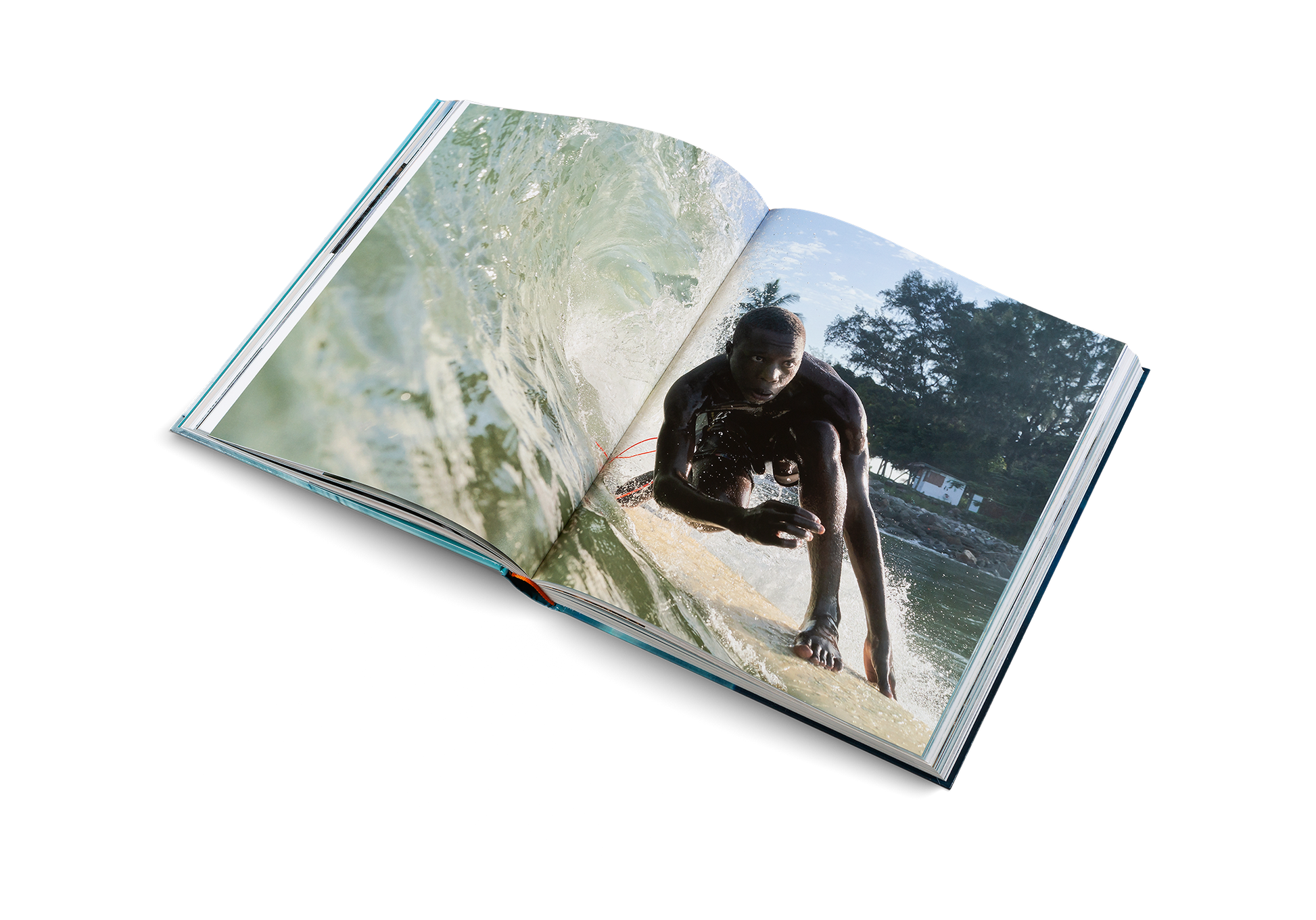 Open book showing a person on a surfboard with a natural background