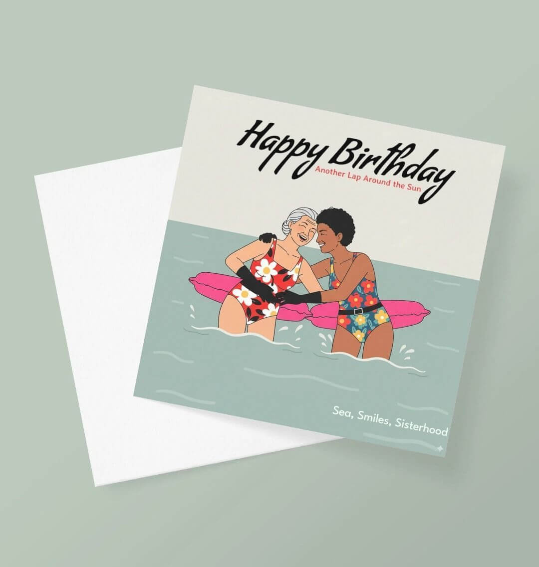 Birthday card with illustration of two people on a raft, text 'Happy Birthday, Another Lap Around the Sun', and 'Sea, Smiles, Sisterhood' on a light green background.