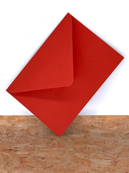 Red paper folded into a triangle on a wooden surface