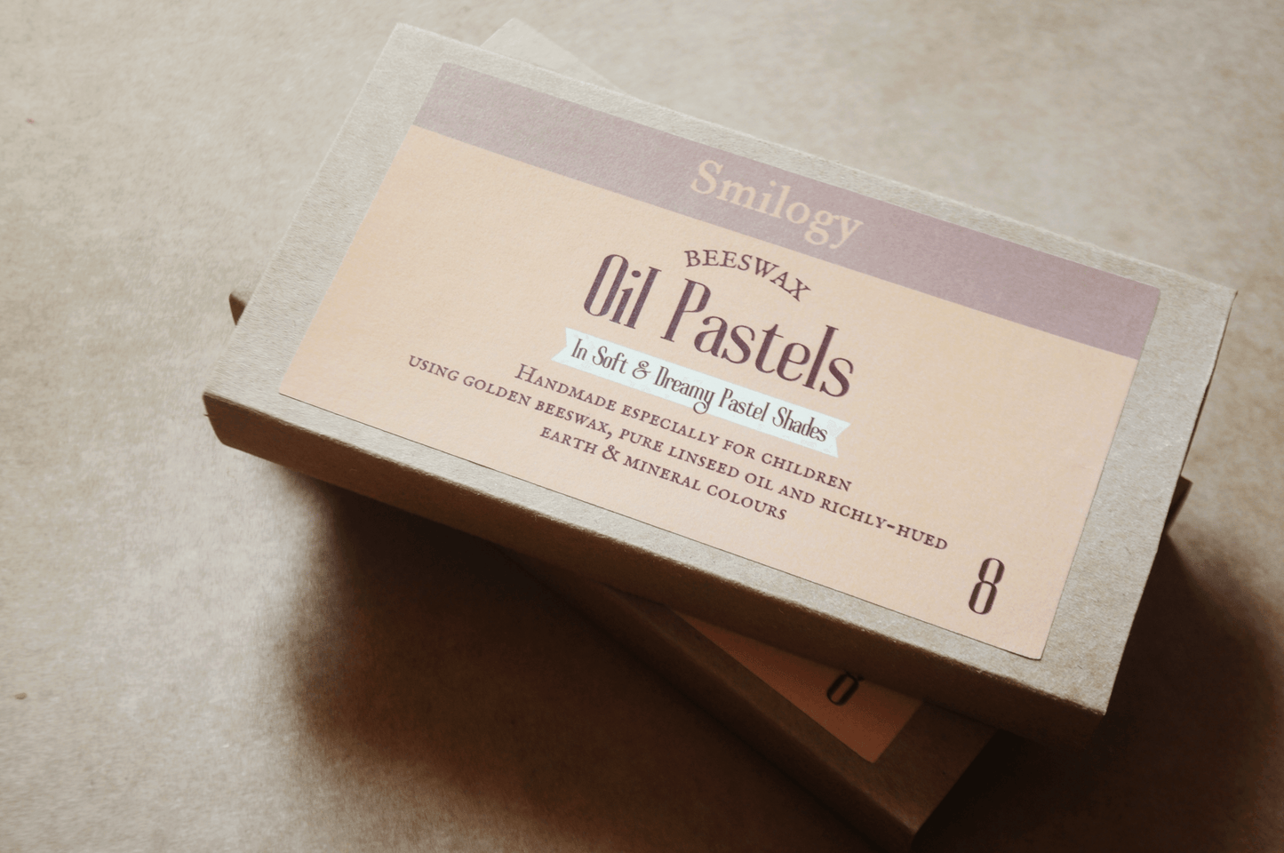 All Natural Beeswax Oil Pastels | Set of 8 Oil Pastels in Soft Pastel Colours packaging on a textured surface.