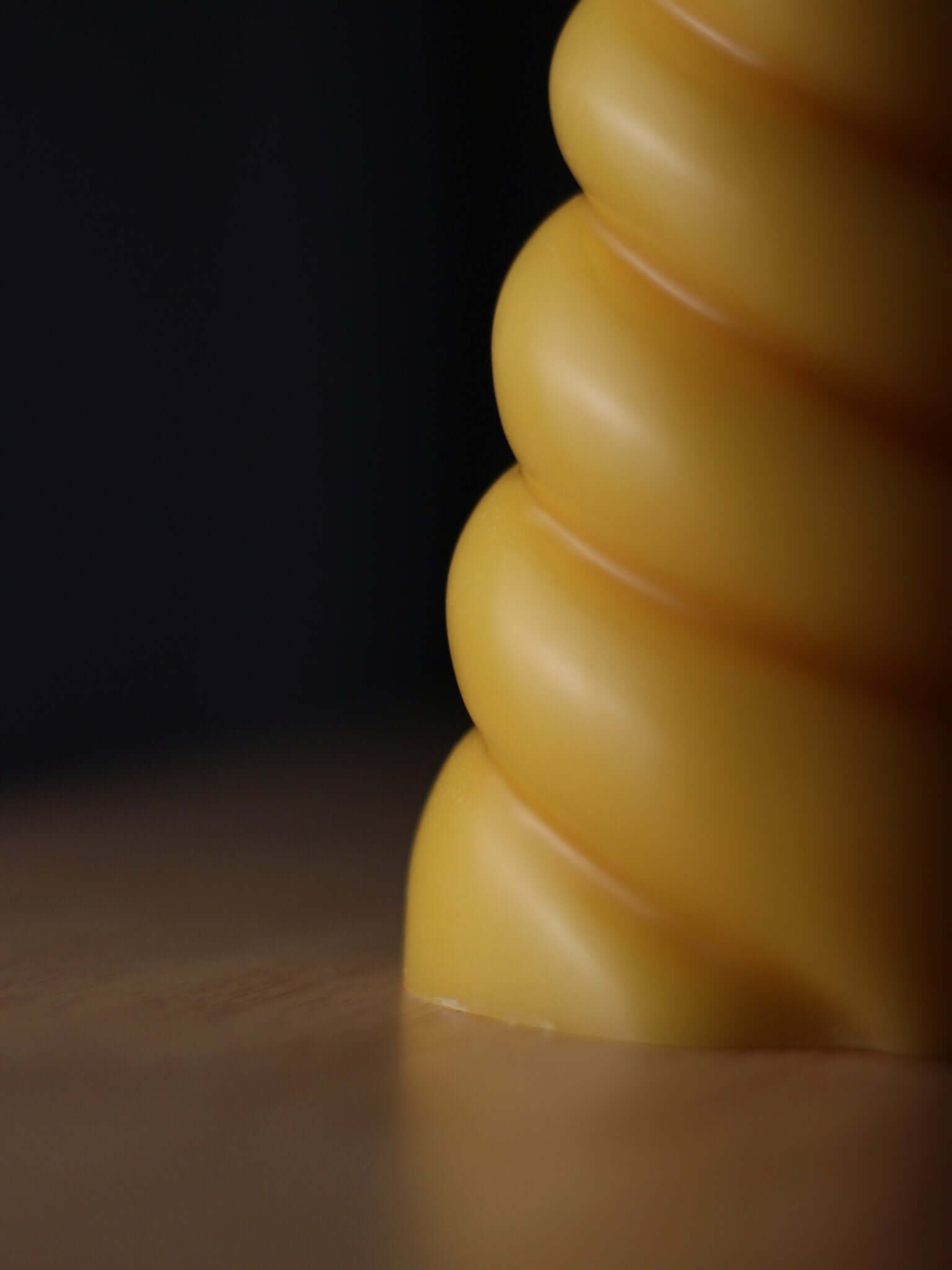 Unicorn horn shaped candle made from beeswax, showcasing the unique twisted design.