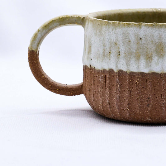 Bianca Arte Handmade Ceramic Terra Stoneware Mug close-up with unique texture and eco-friendly design.