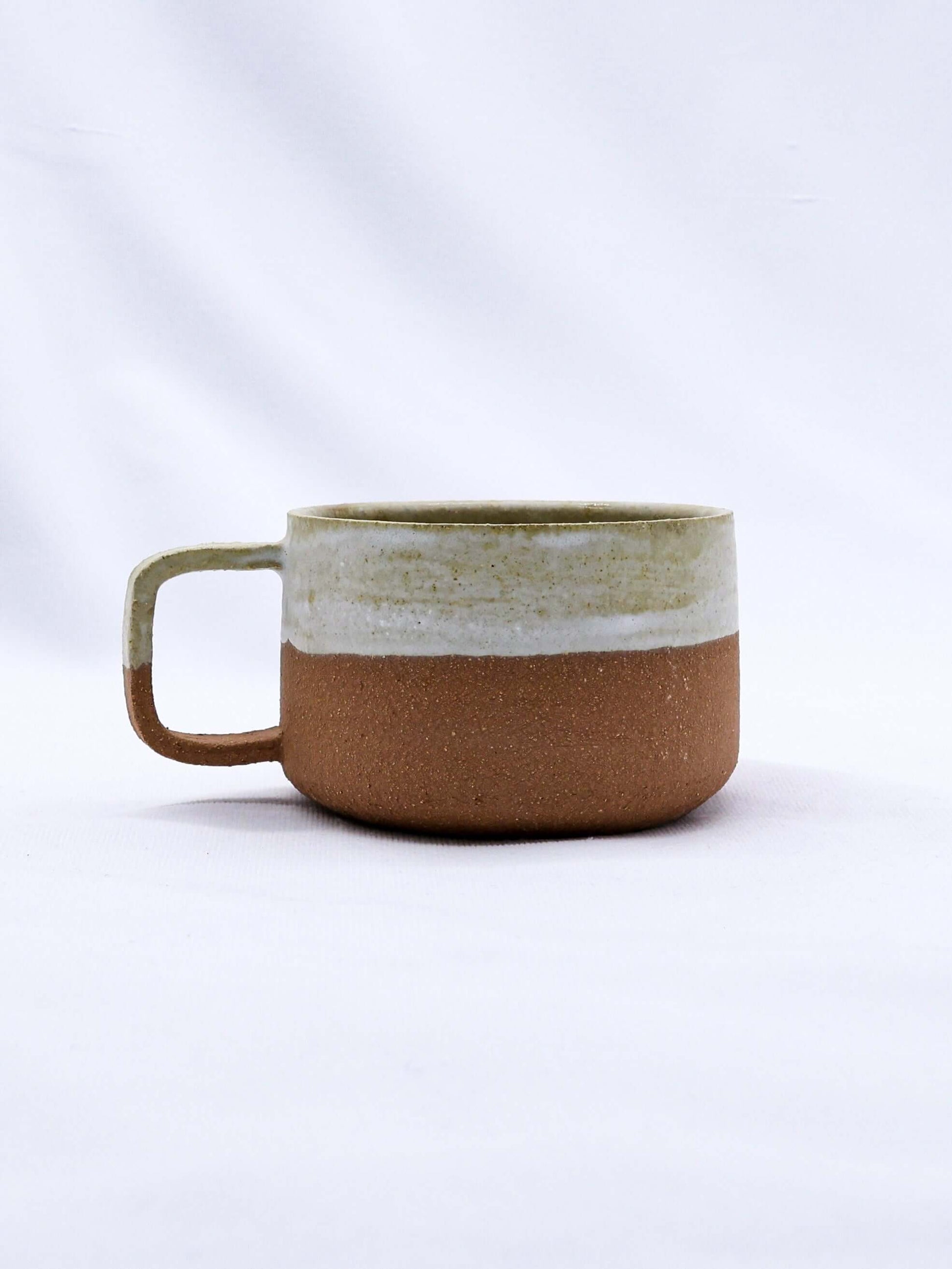 Bianca Grande Handmade Ceramic Terra Stoneware Mug showcasing its elegant two-tone design.