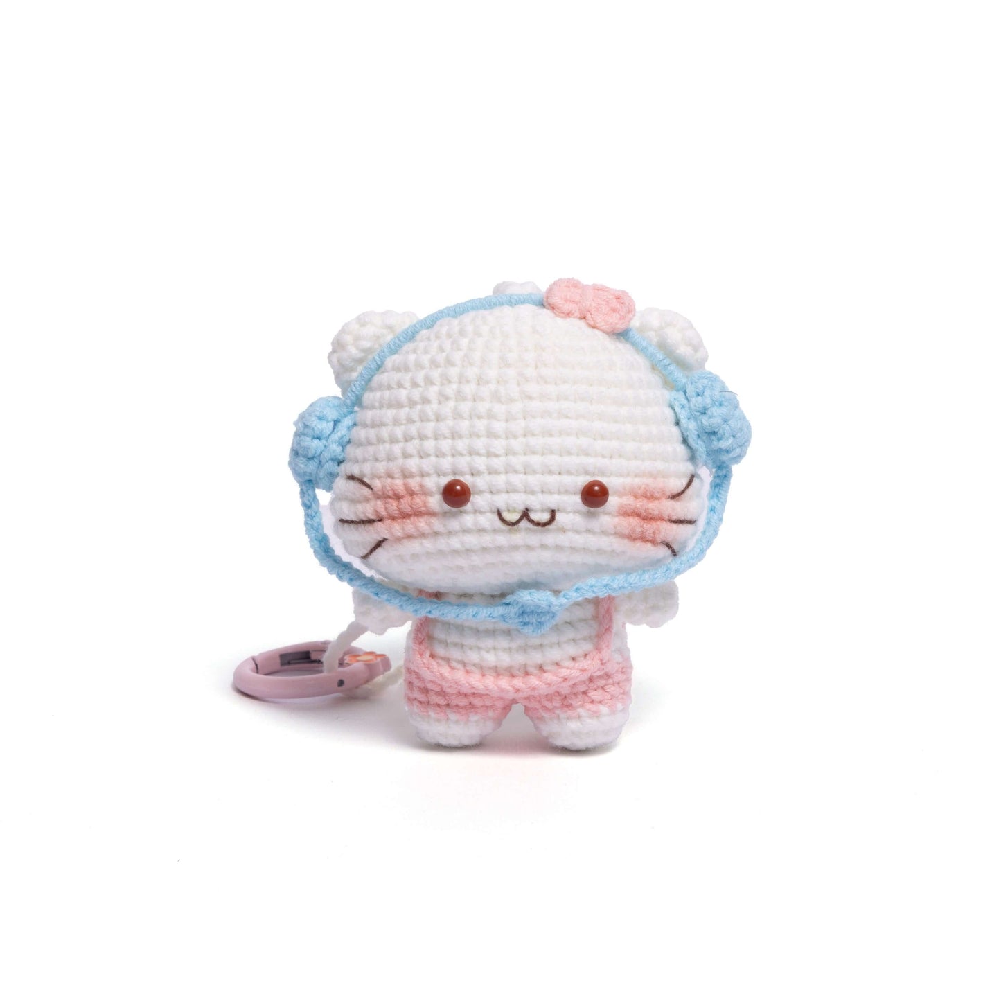 Crocheted cat plush toy with a blue hat on a white background