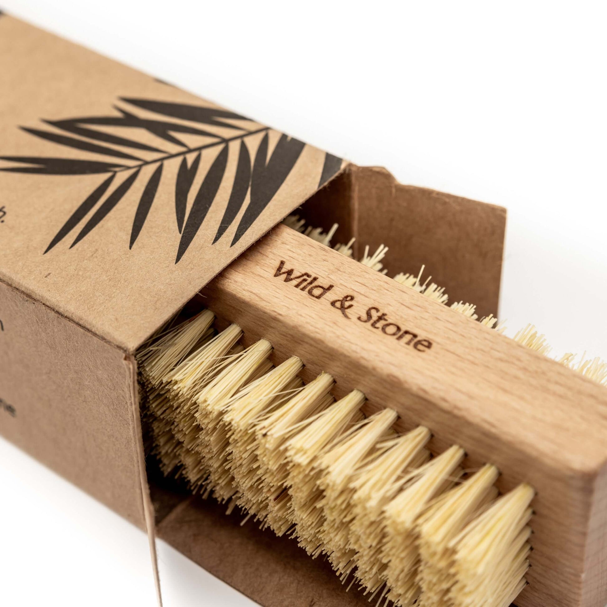 Wooden brush with natural bristles in a 'Wild & Stone' branded box on a white background